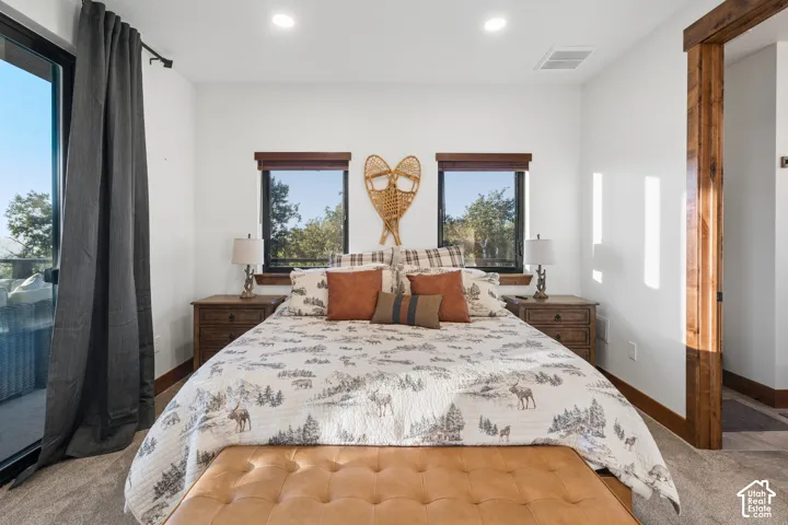 Recessed lighting, wood-finish trim, sliding glass door, and two windows