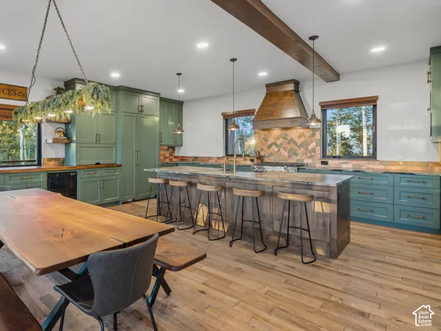 Wood-finish flooring with a multi-tone kitchen island featuring bar seating