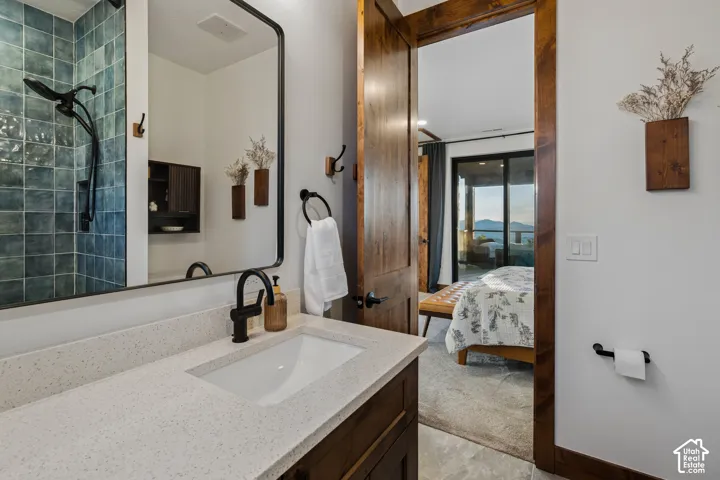 Vanity with an integrated rectangular sink, speckled countertop, and matte black faucet