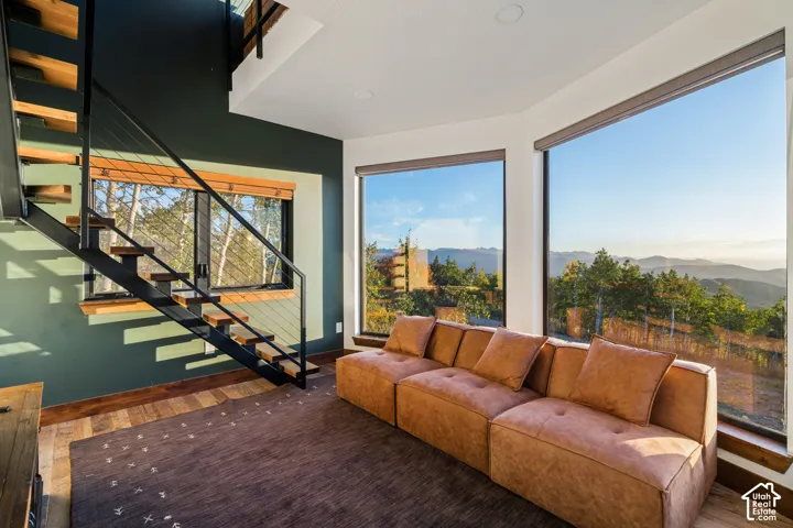 Open-tread staircase with black metal railing and wood treads