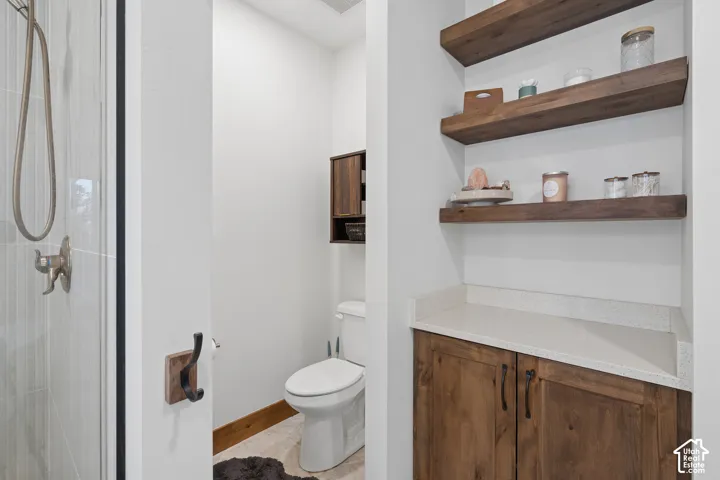 Built-in wooden cabinetry with a light-colored countertop and wooden floating shelves