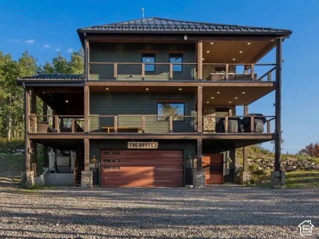Multi-level exterior with dark green siding