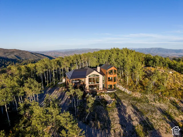 Modern mountain home with a metal roof and stone veneer accents