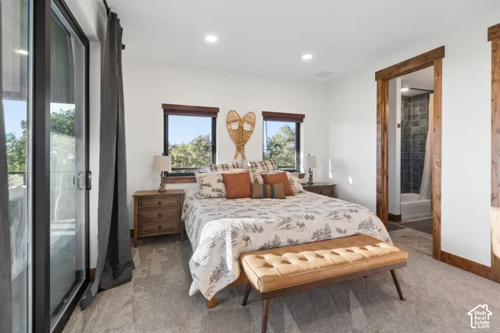 Wood-trimmed windows and doorway, recessed lighting, and a sliding glass door