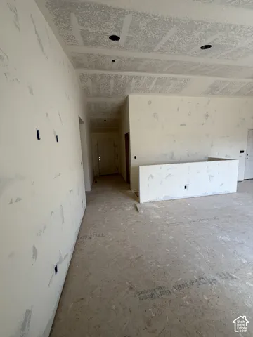 Unfinished interior space featuring drywall with taped seams, recessed lighting, and engineered subflooring