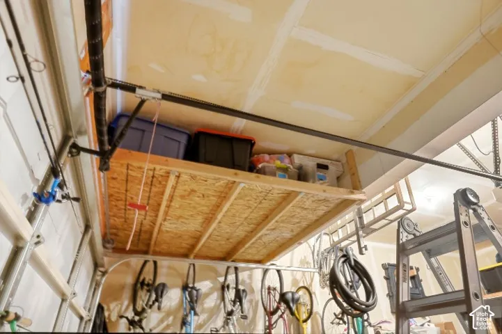 Overhead storage platform featuring integrated wooden framing and ceiling-mounted hardware