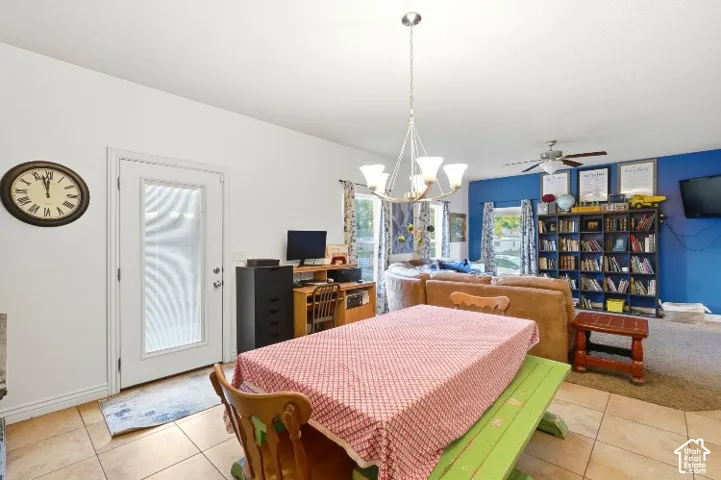 Tile flooring, built-in shelving, ceiling-mounted light fixture, and ceiling fan