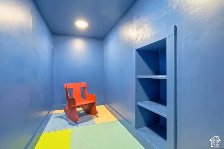 Built-in wall shelving and recessed ceiling lighting