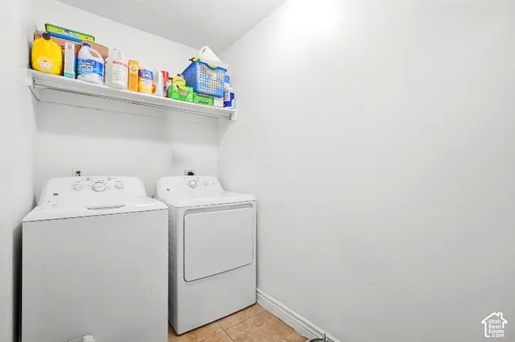 Laundry space featuring ceramic tile flooring and a wall-mounted shelving unit