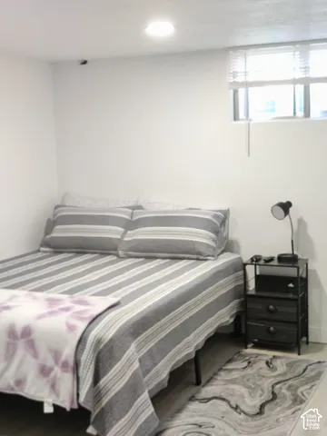 Neutral interior room featuring white walls, recessed ceiling lighting, and a high-set window with integrated blinds