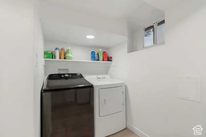 Laundry area featuring recessed ceiling lighting, a built-in wall shelf, and a rectangular window