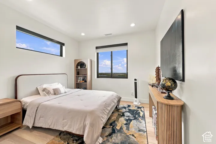 Bright interior featuring wood-finish flooring, recessed lighting, clerestory window, and energy-efficient double-pane windows