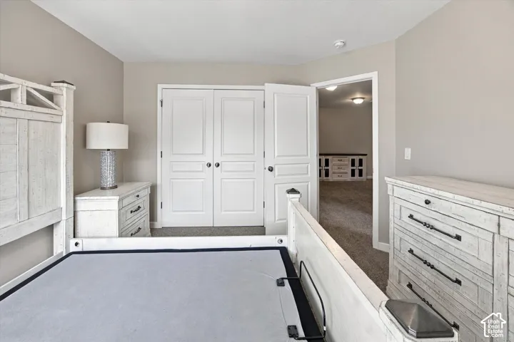 Neutral-toned room featuring wall-to-wall carpeting and double-panel doors