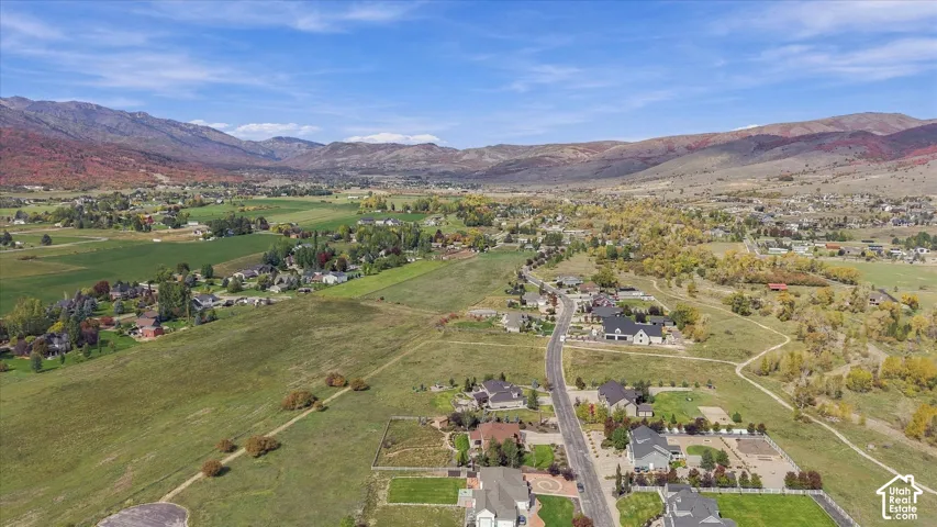 Aerial perspective showcasing expansive terrain, paved thoroughfare, and mountain backdrop
