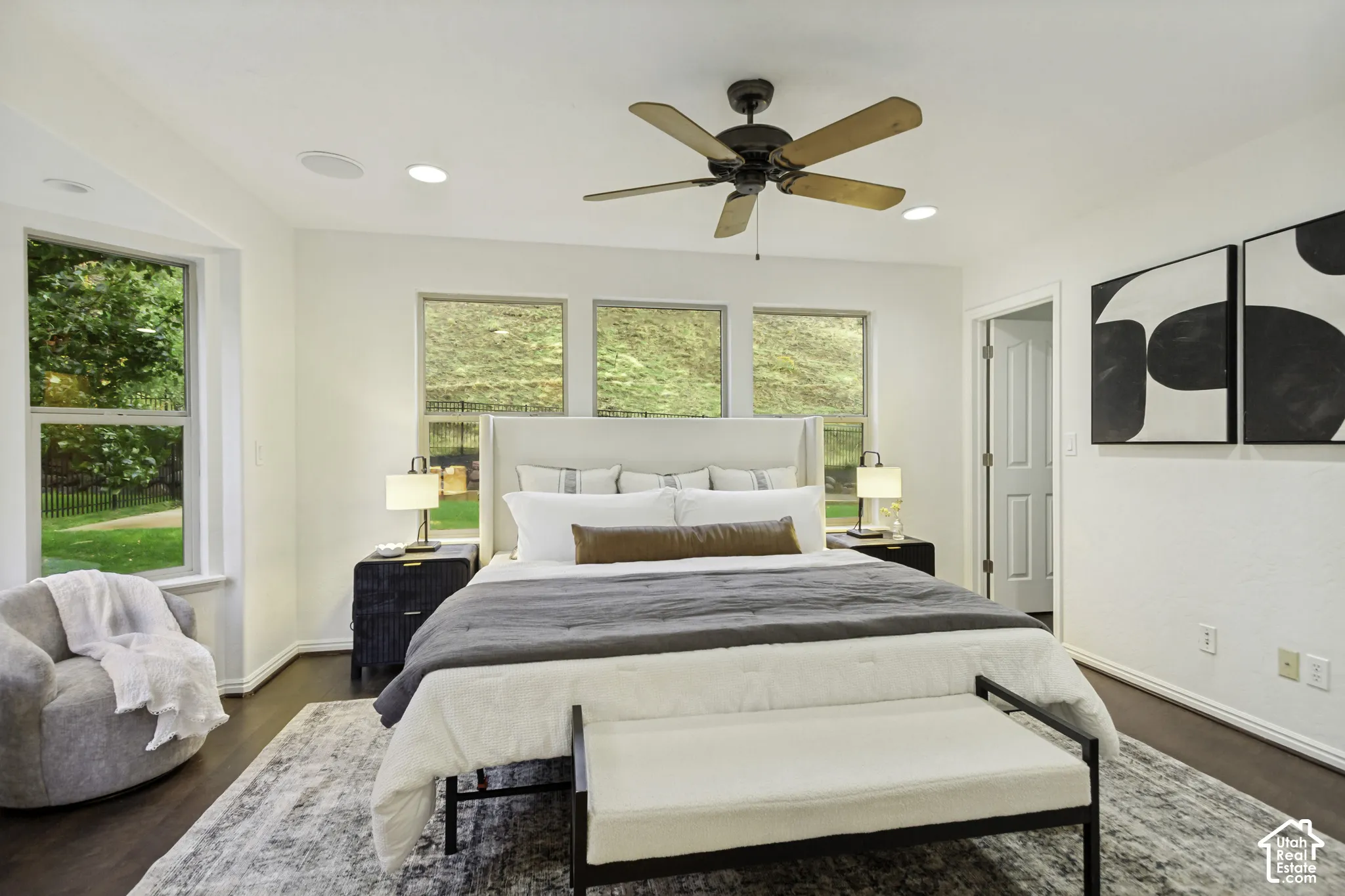 Room featuring wood-finish flooring, recessed lighting, a ceiling fan, and multiple windows