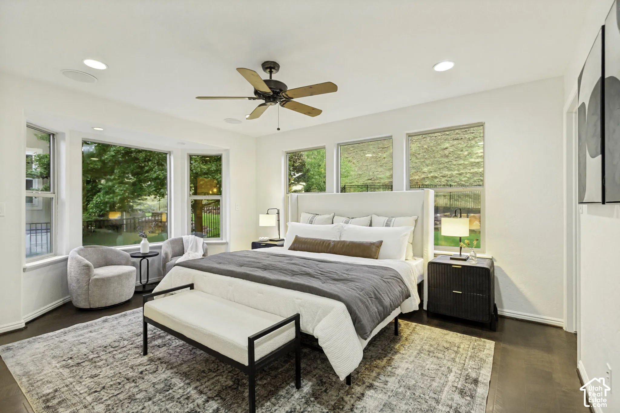 Bedroom featuring wood-finish flooring, recessed lighting, a ceiling fan, and multiple large windows
