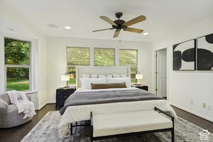 Room featuring wood-finish flooring, recessed lighting, a ceiling fan, and multiple windows
