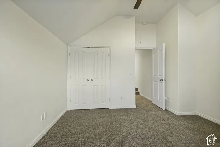 Vaulted ceilings, neutral carpeting, and a double-door closet