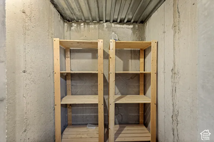 Concrete wall construction with corrugated metal ceiling panels