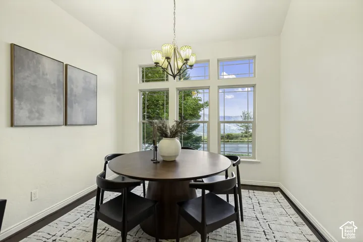 Multi-pane window configuration featuring transom glass, five-arm chandelier with glass shades, and neutral wall tones
