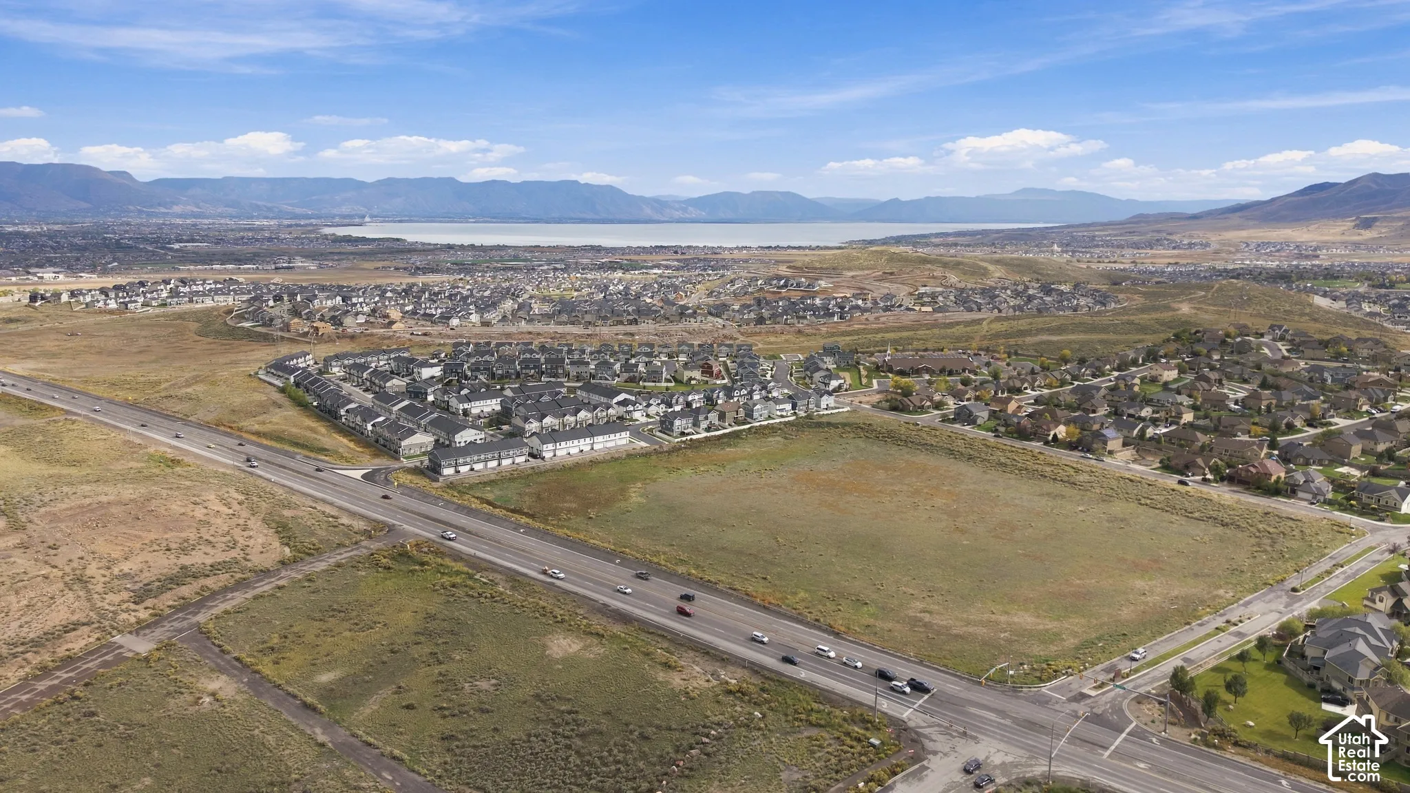 Aerial perspective featuring expansive land with mountain and lake terrain