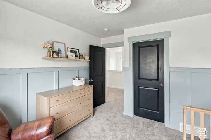 Light blue wainscoting, black interior doors with coordinating door casings, and a neutral-toned flush-mount light fixture