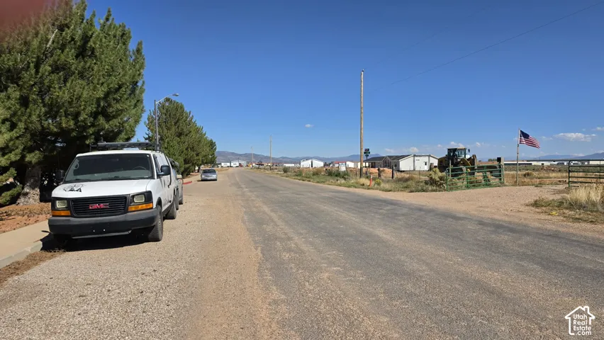 Asphalt road frontage with wide-open perimeter space and mountain scenery