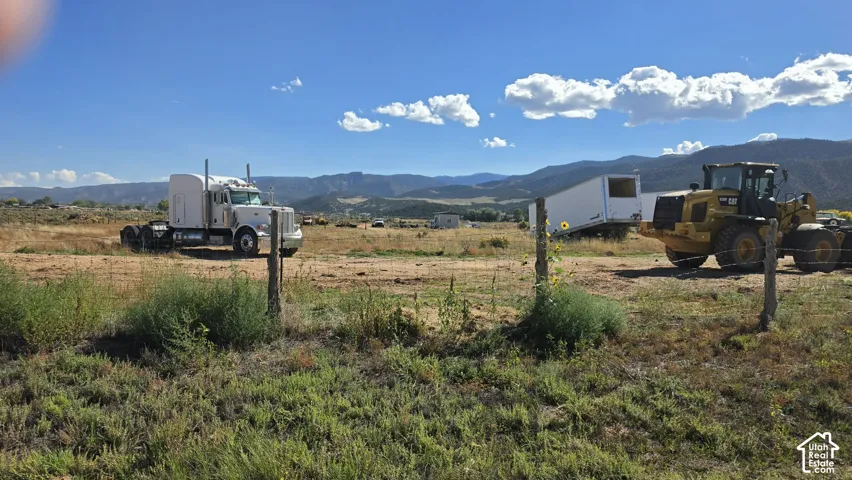 Expansive acreage featuring wire fencing and mountain backdrops