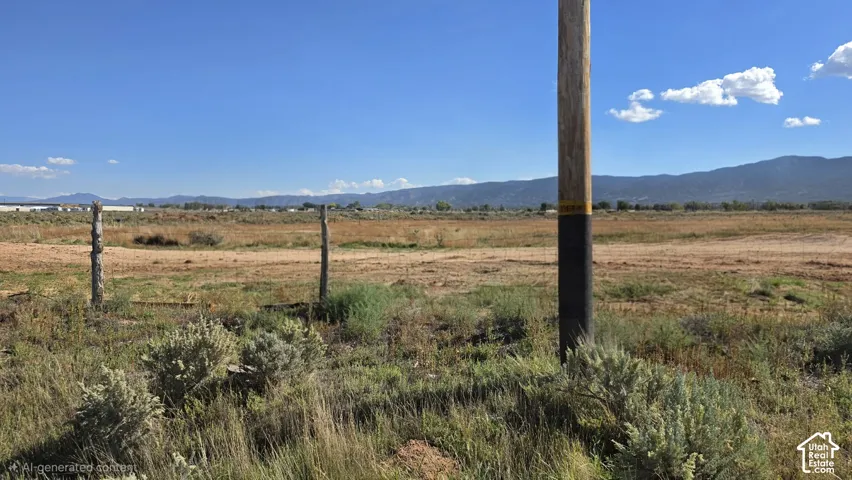 Expansive parcel of land featuring native vegetation and a mountain backdrop