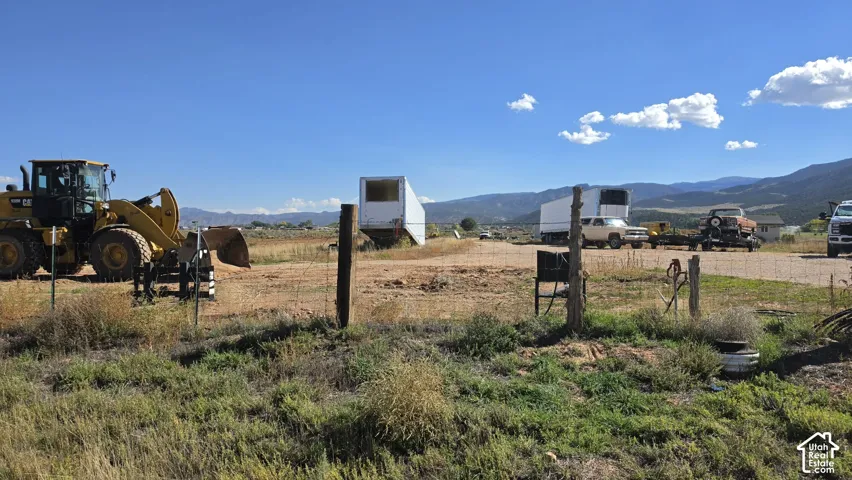 Expansive lot featuring unimproved terrain and mountain backdrops