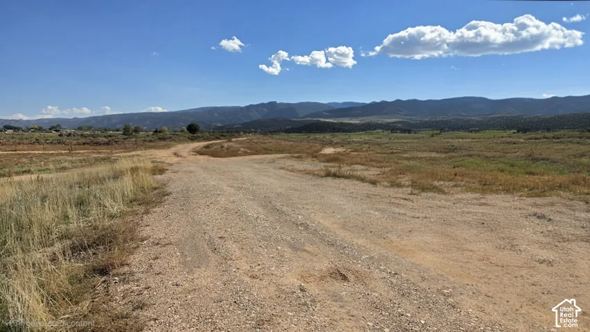 Expansive lot featuring unimproved terrain and mountain backdrop
