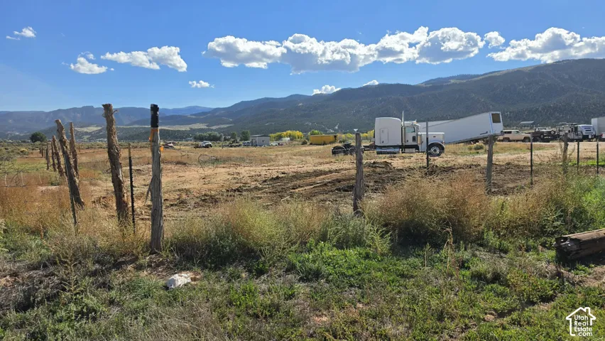 Expansive acreage featuring rugged mountain terrain, native vegetation, and post-and-wire perimeter fencing