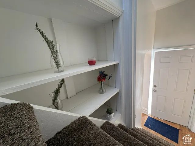 Built-in recessed shelving with painted wood surfaces and a six-panel exterior entry door