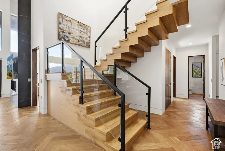 Stairs from main level to upper bedroom wing.