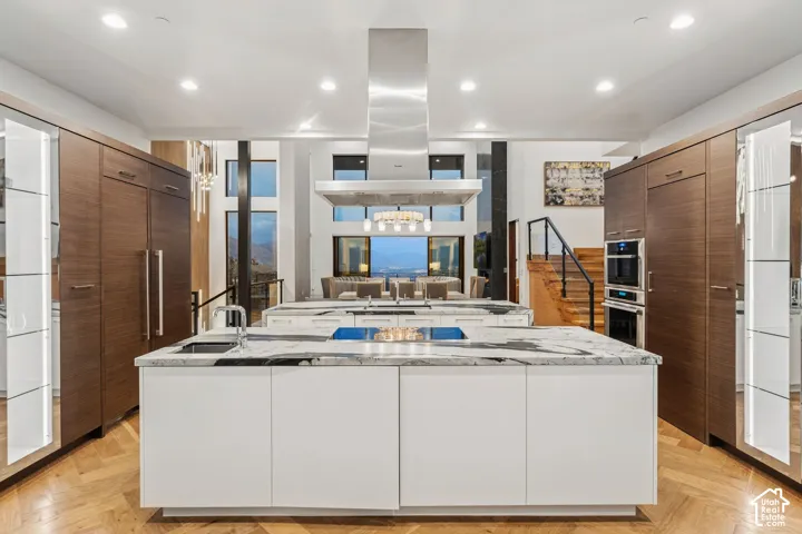 Kitchen with Double islands, thermadore appliances. Grantie couters resembling Brazilian Copacabana Granite with a suede finish