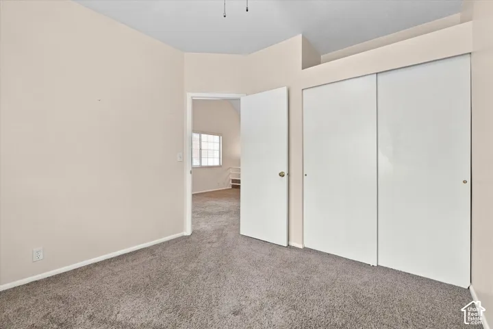 Bedroom #1-Neutral-toned walls, wall-to-wall carpeting, and floor-to-ceiling sliding closet doors