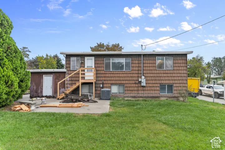 Exterior featuring shingle siding, concrete patio, and elevated wood staircase