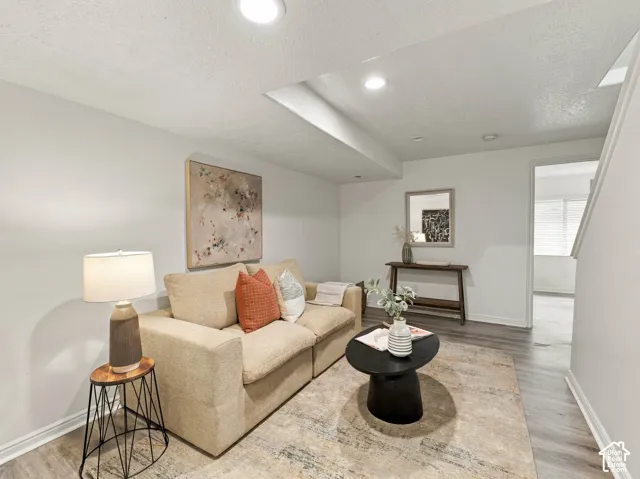 Neutral interior featuring recessed lighting and wood-finish flooring