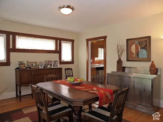 Stained wood trim, matching window casing, wood-finish flooring, and a flush-mount ceiling fixture