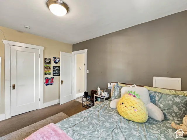 Interior space featuring two-panel interior doors, decorative door casing, neutral wall paint, and a ceiling-mounted light fixture