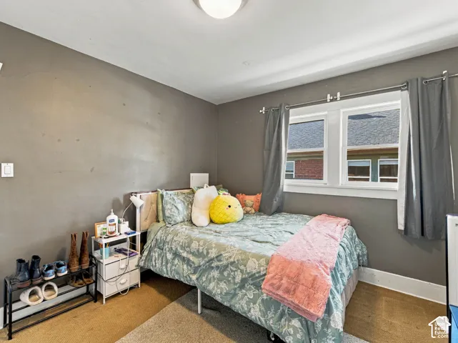 Bedroom with double-pane window, neutral wall paint, and ceiling-mounted light fixture