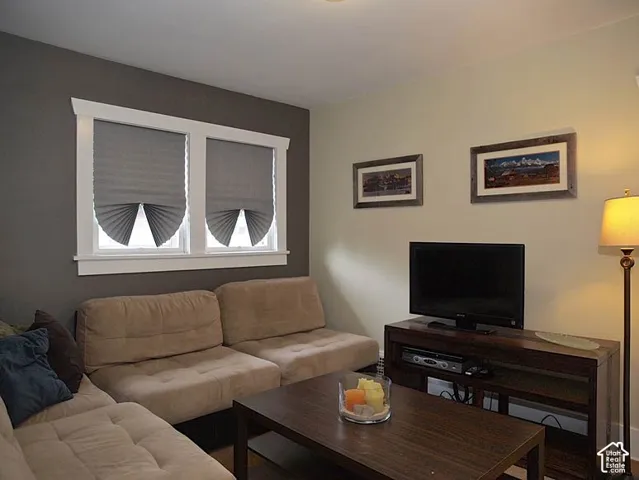 Two-toned interior walls featuring a charcoal accent wall and white-trimmed double windows