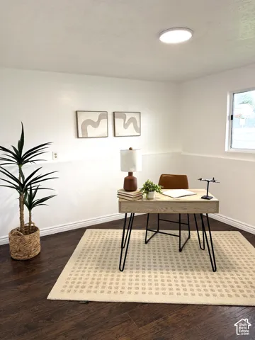 Interior space featuring dark wood-finish flooring, a neutral wall finish, and a ceiling-mounted flush light fixture