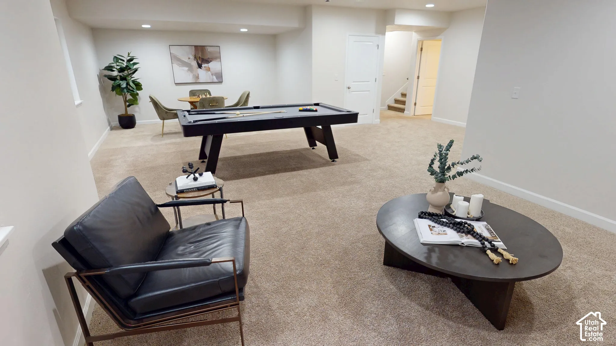 Open-concept interior space featuring wall-to-wall carpeting, recessed ceiling lighting, and solid-core interior doors