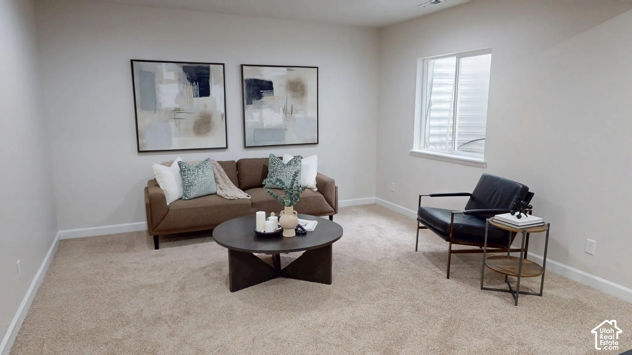 Neutral-toned interior space featuring wall-to-wall carpeting and a single egress window