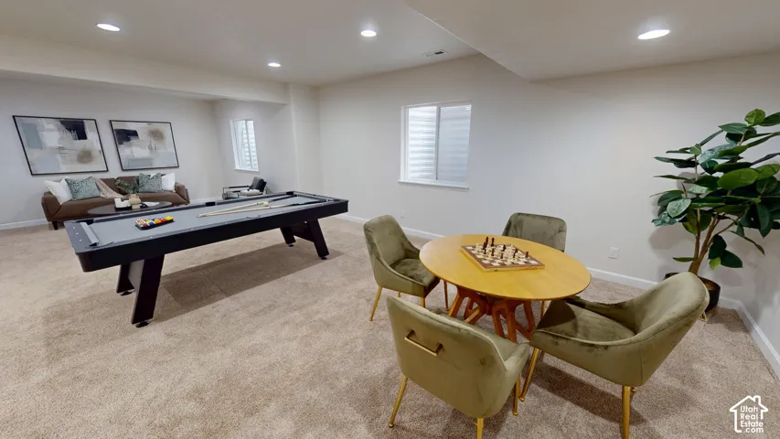 Neutral-toned interior space featuring recessed ceiling lighting, wall-to-wall carpeting, and sliding windows