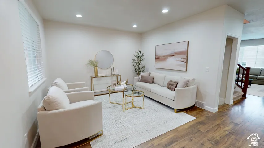 Sitting room featuring wood-finish flooring, recessed lighting, and horizontal window blinds