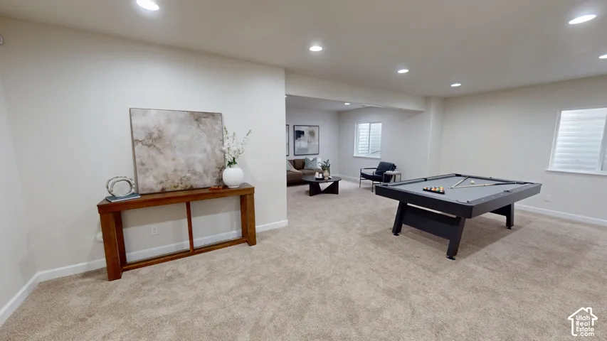 Neutral-toned interior space featuring recessed ceiling lighting, wall-to-wall carpeting, and double-pane windows