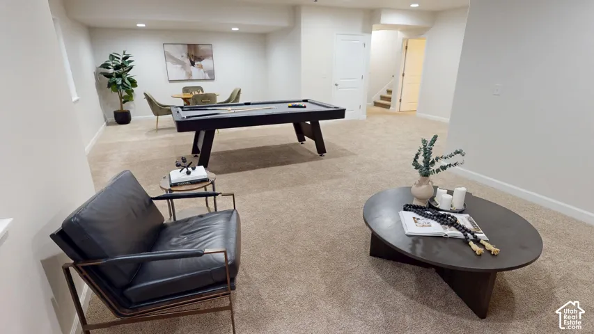 Open-concept interior space featuring wall-to-wall carpeting, recessed ceiling lighting, and solid-core interior doors