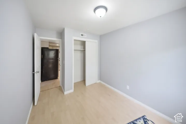 Light wood-finish flooring complements the light gray walls